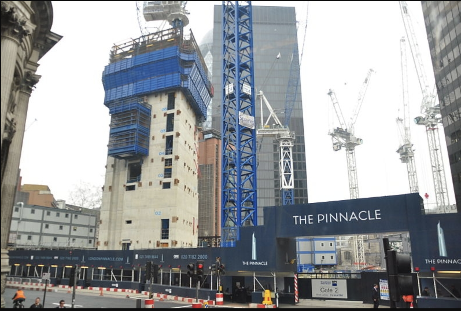A building site with a large concrete core ascending about 10 storeys. A sign reads "The Pinnacle"